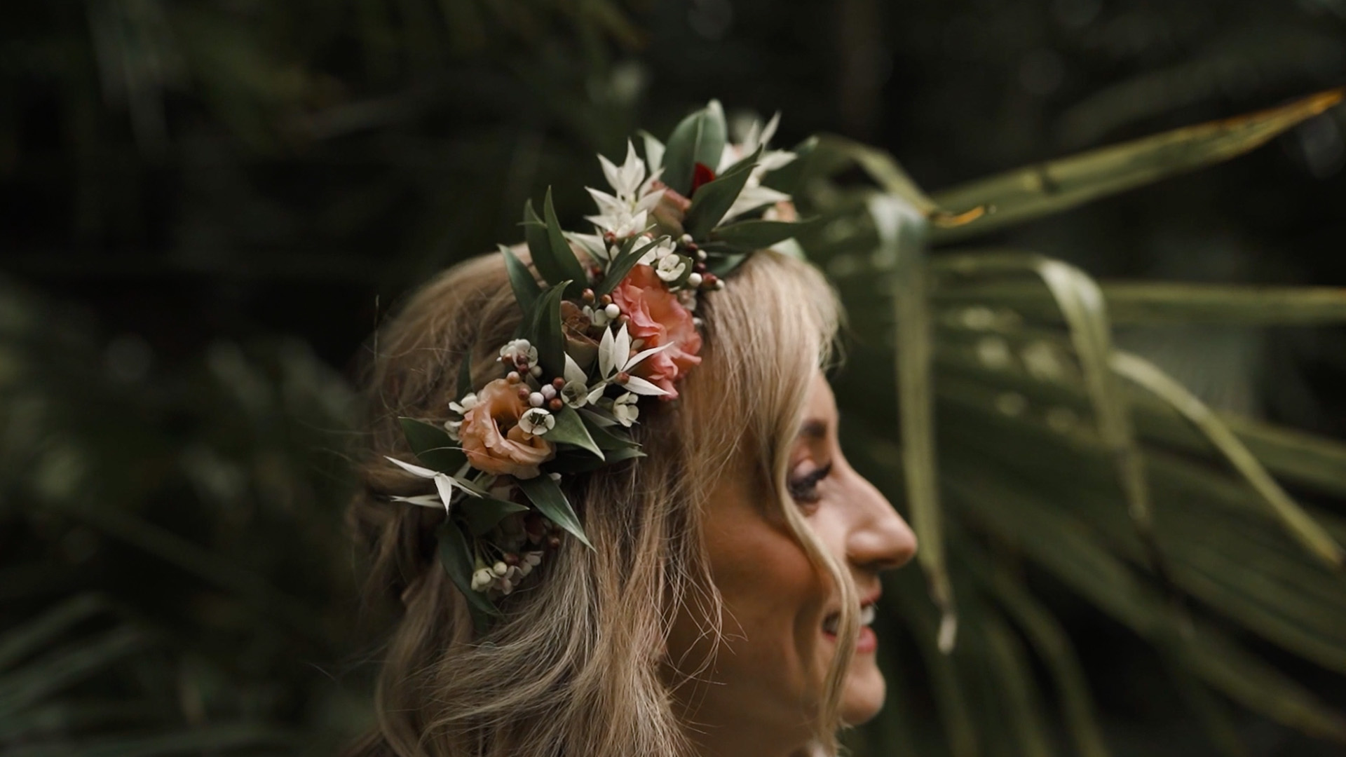 Bride with flower crown amongst greenery